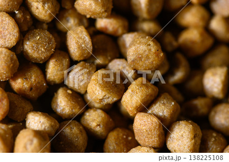 Pet food in close detail reveals texture and color variation as it rests in a bowl during a sunny afternoon 138225108