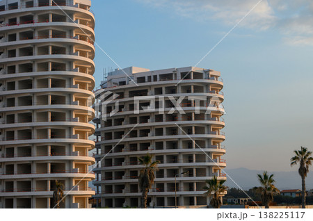 Modern architecture meets serene landscape at sunset in a coastal urban area 138225117