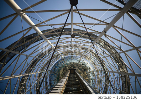 Low Angle View of Futuristic Steel Lattice Tower against Clear Blue Sky, Modern Architectural Engineering and Industrial Geometric Structure, Abstract Vertical Perspective Photography. 138225136