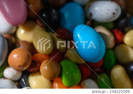 Colorful assortment of candy eggs and sweet treats in vibrant hues for festive Colorful assortment of candy eggs and sweet treats in vibrant hues for festive 138225209