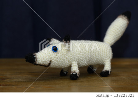 White Knitted Handmade Dog on Dark Background White Knitted Handmade Dog on Dark Background 138225323