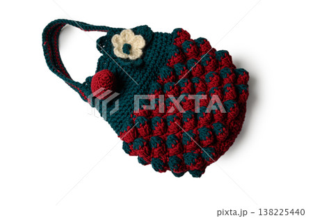 Crocheted Red and Dark Green Tote Bag with Pompoms and Strawberry Applique on White Background. Crocheted Red and Dark Green Tote Bag with Pompoms and Strawberry Applique on White Background. 138225440