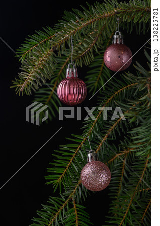 Three Delicate Pink Ornaments on Fluffy Spruce Branch Three Delicate Pink Ornaments on Fluffy Spruce Branch 138225781