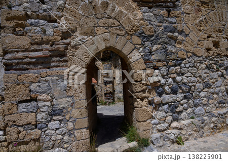 Close-up of the ancient stone wall of St. Hilarion Castle in Northern Cyprus. Weathered stones reflect the medieval history of the mountain fortress. Close-up of the ancient stone wall of St. Hilarion Castle in Northern Cyprus. Weathered stones reflect the medieval history of the mountain fortress. 138225901
