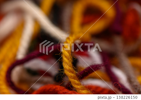 Soft and colorful knitting threads shown in a detailed close-up. Perfect for crafting content, textile blogs, or handmade product promos. 138226150