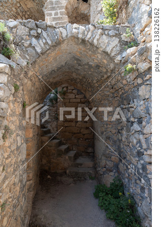 Stone room with narrow windows and arched ceiling inside Saint Hilarion Castle, showcasing medieval military architecture of Northern Cyprus. 138226162