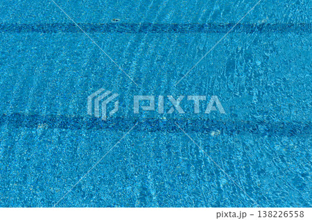 Clear Blue Pool Water Surface Texture in Sunlight Background Clear Blue Pool Water Surface Texture in Sunlight Background 138226558