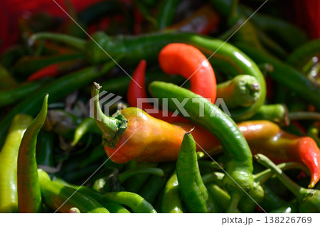 Freshly harvested chili peppers at a vibrant local market in the heart of summer Freshly harvested chili peppers at a vibrant local market in the heart of summer 138226769