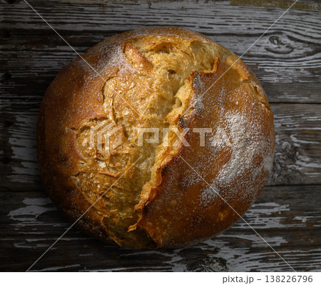 Freshly baked round loaf resting on rustic wooden table ready delightful meal 138226796