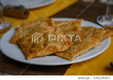 Delicious freshly fried pastries served on a white plate with a vibrant yellow Delicious freshly fried pastries served on a white plate with a vibrant yellow 138226927