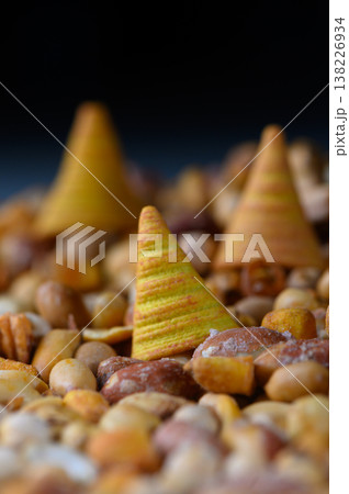 Colorful cones nestled among an array of earthy nuts create a whimsical landscape that sparks curiosity and delight 138226934