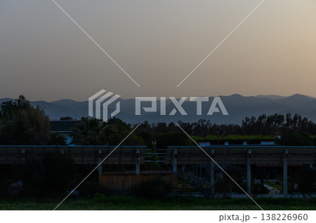 Tranquil twilight landscape with hazy mountains and serene stillness at dusk in a rural setting 138226960