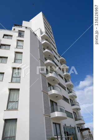 Modern architecture showcases sleek design in a vibrant urban setting under a clear blue sky 138226967