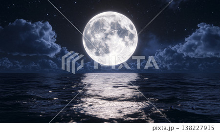 Full moon illuminating the rippling ocean surface under a clear night sky, soft clouds and shimmering reflections 138227915