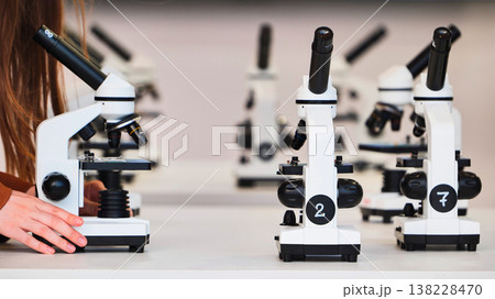 Student learning biology using microscope in science laboratory classroom Student learning biology using microscope in science laboratory classroom 138228470