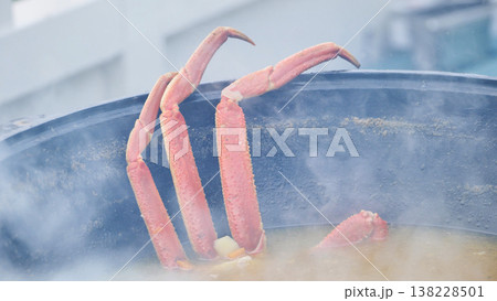 Crab legs cooking in a steaming pot, preparing a delicious seafood meal 138228501