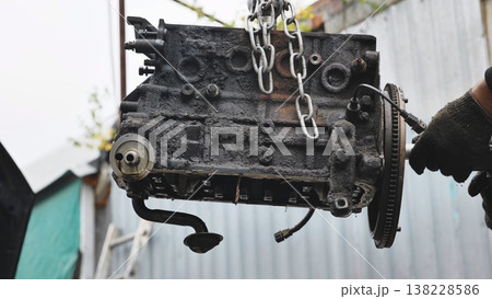 Old dirty car engine block lifting for repair 138228586