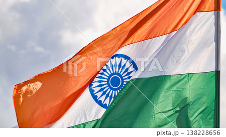 India flag with tricolor and Ashoka Chakra waving in wind on cloudy day India flag with tricolor and Ashoka Chakra waving in wind on cloudy day 138228656