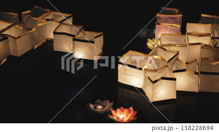 Paper river lanterns floating at night during festival Paper river lanterns floating at night during festival 138228694