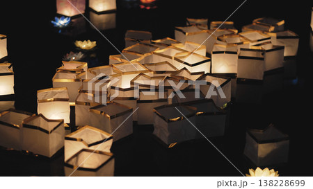 Floating paper river lanterns illuminating dark water 138228699