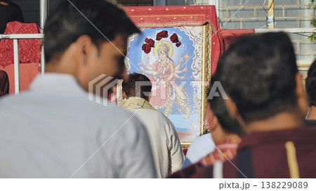 Indian devotees celebrating Durga Puja festival, offering prayers to goddess Durga 138229089
