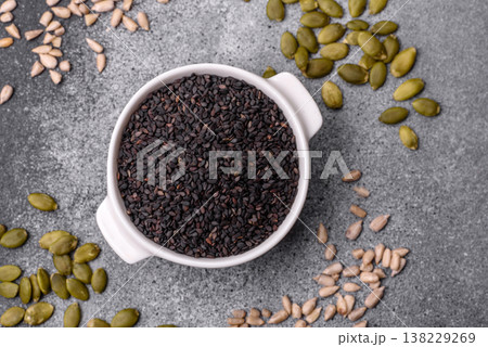 Black sesame seeds in a bowl, an ingredient for oil and healthy eating. Black sesame Black sesame seeds in a bowl, an ingredient for oil and healthy eating. Black sesame 138229269