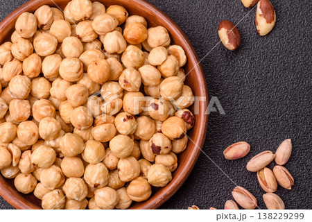 Whole peeled hazelnuts, roasted or raw, as an ingredient for healthy food. Hazelnuts as a background Whole peeled hazelnuts, roasted or raw, as an ingredient for healthy food. Hazelnuts as a background 138229299