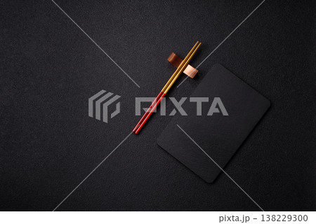An empty slate cutting board with cutlery on a kitchen counter. Slate cutting board 138229300