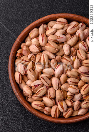Salted pistachio nuts in shells as a healthy, high calorie food ingredient. Pistachio nuts Salted pistachio nuts in shells as a healthy, high calorie food ingredient. Pistachio nuts 138229312