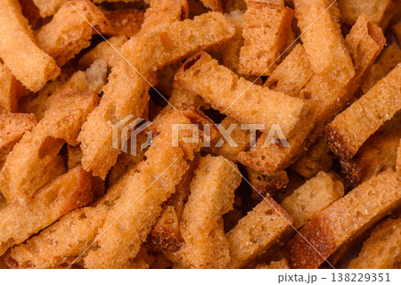 Croutons or crackers made from rye bread with garlic, salt, and spices. Croutons with salt Croutons or crackers made from rye bread with garlic, salt, and spices. Croutons with salt 138229351