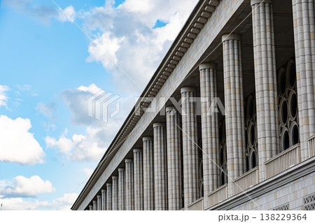 Modern classical architecture with repeating columns under a bright blue sky Modern classical architecture with repeating columns under a bright blue sky 138229364