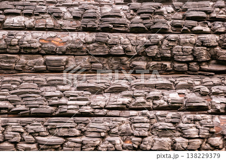 Burnt timber surface featuring black carbonized texture from fire 138229379