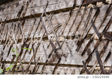 Weathered wooden wall texture with diagonal lath creating a rustic pattern 138229380