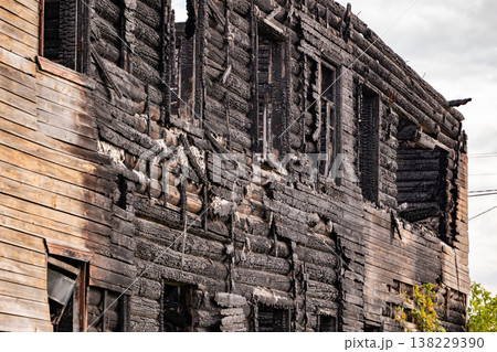 Charred wooden house facade remaining after a devastating fire disaster Charred wooden house facade remaining after a devastating fire disaster 138229390