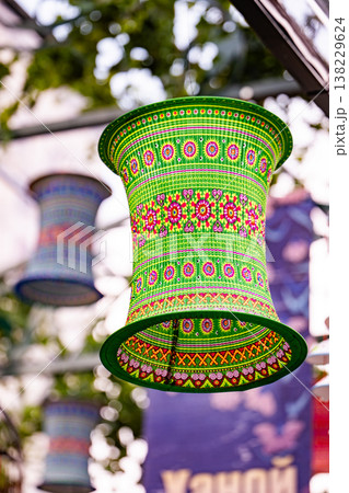 Green handmade decorative Vietnamese paper lantern hanging outdoor 138229624