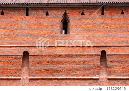 Moscow Kremlin red brick fortress wall with loopholes and architectural details 138229646