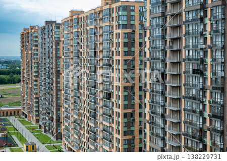 Modern residential complex featuring multiple high-rise apartment buildings and green spaces 138229731