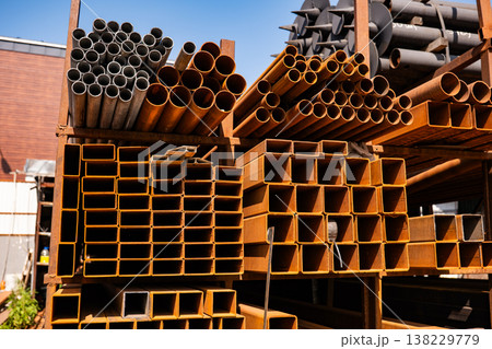 Stacked steel pipes and channels creating industrial construction material background Stacked steel pipes and channels creating industrial construction material background 138229779