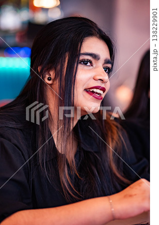 Young indian woman laughing, smiling with red lips and dark hair Young indian woman laughing, smiling with red lips and dark hair 138229901