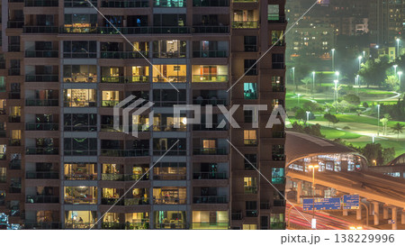Lights in windows of modern multiple story building in urban setting at night timelapse Lights in windows of modern multiple story building in urban setting at night timelapse 138229996