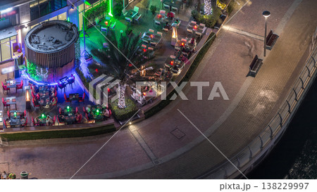 Modern embankment night timelapse with Cafe and Restaurant in Dubai Marina Modern embankment night timelapse with Cafe and Restaurant in Dubai Marina 138229997