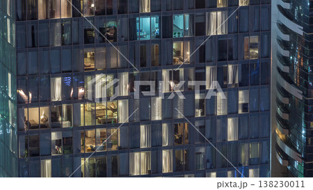 Night view of exterior apartment tower timelapse. High rise skyscraper with blinking lights in windows Night view of exterior apartment tower timelapse. High rise skyscraper with blinking lights in windows 138230011