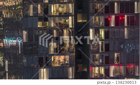 Night view of exterior apartment tower timelapse. High rise skyscraper with blinking lights in windows Night view of exterior apartment tower timelapse. High rise skyscraper with blinking lights in windows 138230013