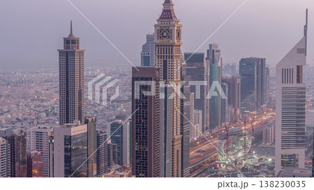 Skyline of the buildings of Sheikh Zayed Road and DIFC aerial night to day timelapse in Dubai, UAE. Skyline of the buildings of Sheikh Zayed Road and DIFC aerial night to day timelapse in Dubai, UAE. 138230035
