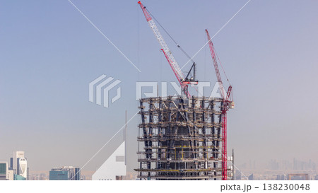 Construction of new modern skyscraper in Dubai city aerial timelapse, United Arab Emirates Construction of new modern skyscraper in Dubai city aerial timelapse, United Arab Emirates 138230048