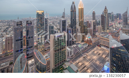 Skyline of the buildings of Sheikh Zayed Road and DIFC aerial day to night timelapse in Dubai, UAE. Skyline of the buildings of Sheikh Zayed Road and DIFC aerial day to night timelapse in Dubai, UAE. 138230057