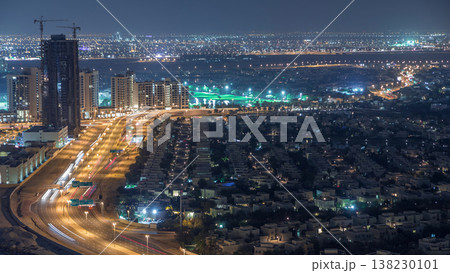 Aerial view of apartment houses and villas in Dubai city night timelapse, United Arab Emirates 138230101