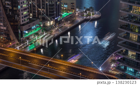 Waterfront promenade in Dubai Marina aerial night timelapse. Dubai, United Arab Emirates Waterfront promenade in Dubai Marina aerial night timelapse. Dubai, United Arab Emirates 138230123