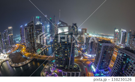Aerial view of Dubai Marina residential and office skyscrapers with waterfront night timelapse Aerial view of Dubai Marina residential and office skyscrapers with waterfront night timelapse 138230126