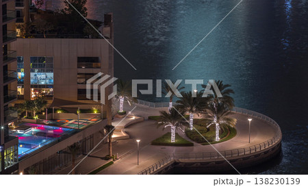 Waterfront promenade in Dubai Marina aerial night timelapse. Dubai, United Arab Emirates Waterfront promenade in Dubai Marina aerial night timelapse. Dubai, United Arab Emirates 138230139